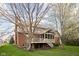 Beautiful backyard showcasing a multi-level deck, screened porch, mature trees, and lush green lawn at 4777 Madras Ct, Zionsville, IN 46077