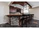 Inviting basement bar featuring stone accents, wooden countertops, and comfortable seating for entertainment at 4777 Madras Ct, Zionsville, IN 46077