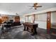 Spacious basement with a foosball table, stone fireplace, and ample seating for relaxation and entertainment at 4777 Madras Ct, Zionsville, IN 46077