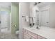 Charming bathroom with a white vanity, soft green walls, and tiled floors, offering a refreshing and inviting space at 4777 Madras Ct, Zionsville, IN 46077