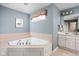Bathroom featuring a large jacuzzi tub and -and- sinks, perfect for relaxation and convenience at 4777 Madras Ct, Zionsville, IN 46077