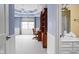 View of a spacious bedroom leading into an ensuite bathroom with a stylish vanity and fixtures at 4777 Madras Ct, Zionsville, IN 46077