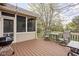 Inviting backyard deck features comfortable seating, a grill, and a screened porch, perfect for outdoor entertaining at 4777 Madras Ct, Zionsville, IN 46077