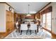 Formal dining room with wood floors, stylish rug, and adjacent to the kitchen at 4777 Madras Ct, Zionsville, IN 46077