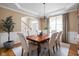 Elegant dining room with wainscoting, modern chandelier, and hardwood floors at 4777 Madras Ct, Zionsville, IN 46077