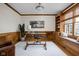 Stylish home office with custom built-ins, wood paneling, and cozy window seating at 4777 Madras Ct, Zionsville, IN 46077