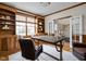 Home office features built-in shelving and desk, a window seat, and hardwood floors at 4777 Madras Ct, Zionsville, IN 46077