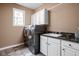 Laundry room featuring modern washer and dryer, sink, and storage cabinets at 4777 Madras Ct, Zionsville, IN 46077