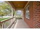 Covered porch featuring classic columns, wood ceiling, brick wall and view of the neighborhood at 4777 Madras Ct, Zionsville, IN 46077