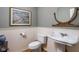 Classic powder room featuring a pedestal sink, decorative mirror, and beadboard paneling at 4777 Madras Ct, Zionsville, IN 46077