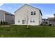 Rear view of the house displaying a grassy lawn and neutral siding at 4831 E Oak Hill E Dr, Lebanon, IN 46052