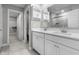 Well-lit bathroom with a double sink vanity, white cabinets, a large mirror, and easy access to a shower and walk-in closet at 4831 E Oak Hill E Dr, Lebanon, IN 46052