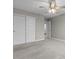 Carpeted bedroom with ceiling fan, closet, and an open doorway to a bathroom provides comfort and convenience at 4831 E Oak Hill E Dr, Lebanon, IN 46052