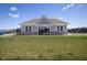 Community clubhouse featuring neutral siding and brick accents, set against a backdrop of vibrant green lawn at 4831 E Oak Hill E Dr, Lebanon, IN 46052