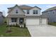 Charming two-story home boasts a two-car garage and meticulously landscaped front yard at 4831 E Oak Hill E Dr, Lebanon, IN 46052