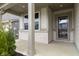 Inviting front porch featuring neutral-toned siding, white brick, and a stylish storm door at 4831 E Oak Hill E Dr, Lebanon, IN 46052
