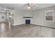 Open-concept living area with fireplace, ceiling fan and wood-look flooring at 4831 E Oak Hill E Dr, Lebanon, IN 46052