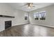 Comfortable living room with fireplace, ceiling fan, and large windows offering ample natural light at 4831 E Oak Hill E Dr, Lebanon, IN 46052