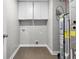 Functional utility room with a water heater, white cabinets, and washer-dryer hookups for seamless laundry chores at 4831 E Oak Hill E Dr, Lebanon, IN 46052