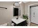 Modern bathroom featuring vanity, large mirror, updated fixtures, and sliding barn door at 500 N Shellbark Rd, Muncie, IN 47304