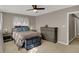 Comfortable bedroom with neutral tones, ceiling fan, and ample storage space at 500 N Shellbark Rd, Muncie, IN 47304