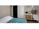 Cozy bedroom featuring a colorful bedspread, hardwood floors, and a stylish cabinet with decor at 500 N Shellbark Rd, Muncie, IN 47304