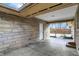 View of the carport leading to the fenced backyard with a landscaped area at 500 N Shellbark Rd, Muncie, IN 47304