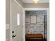 Charming entryway nook with shiplap accents, a cozy bench, and coat rack for a welcoming feel at 500 N Shellbark Rd, Muncie, IN 47304