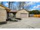Exterior view of a garage with stone siding, a well-maintained driveway, and manicured landscaping at 500 N Shellbark Rd, Muncie, IN 47304