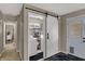 Hallway showcasing a barn door that leads to the laundry room, next to the exterior door at 500 N Shellbark Rd, Muncie, IN 47304