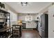 Bright kitchen with stainless steel appliances, white cabinets, wood floors, and a breakfast nook at 500 N Shellbark Rd, Muncie, IN 47304