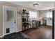 Bright kitchen with white cabinetry, stainless steel appliances, wood flooring, and a cozy dining area at 500 N Shellbark Rd, Muncie, IN 47304