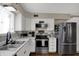 Updated kitchen showcases stainless steel appliances, white cabinets, and stylish backsplash at 500 N Shellbark Rd, Muncie, IN 47304