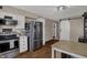Kitchen featuring stainless steel appliances and a sliding barn door at 500 N Shellbark Rd, Muncie, IN 47304