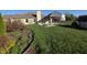Spacious backyard with a well-manicured lawn and a charming pergola-covered patio at 52 Spring Lake Ct, Trafalgar, IN 46181