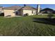 Expansive backyard features a lush lawn, barbecue grill, and pergola-covered patio at 52 Spring Lake Ct, Trafalgar, IN 46181