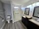 Modern bathroom with tiled shower, dual sinks, and accessible grab bars at 52 Spring Lake Ct, Trafalgar, IN 46181