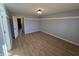 Open bedroom with light wood flooring and neutral walls at 52 Spring Lake Ct, Trafalgar, IN 46181