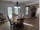 View of the dining area adjacent to a brick fireplace and featuring a chandelier at 52 Spring Lake Ct, Trafalgar, IN 46181