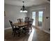 Cozy dining area with wood table, chandelier, and easy access to the backyard at 52 Spring Lake Ct, Trafalgar, IN 46181