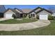 Lovely brick home with manicured lawn, an American flag, and two-car garage at 52 Spring Lake Ct, Trafalgar, IN 46181