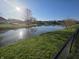 Picturesque view of a tranquil pond surrounded by lush greenery and neighborhood homes at 52 Spring Lake Ct, Trafalgar, IN 46181