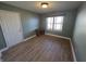 Bedroom or office with desk, wood-look floors, and natural light from the window at 52 Spring Lake Ct, Trafalgar, IN 46181
