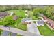 Aerial shot of a home with spacious yard, outbuildings, and gravel drive, surrounded by trees and other homes at 5301 Old Smith Valley Rd, Greenwood, IN 46143