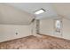 Attic featuring carpeting and a view through a doorway at 5301 Old Smith Valley Rd, Greenwood, IN 46143