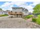 Home with gravel driveway, wooden deck, and backyard with landscaping elements; ideal for outdoor living at 5301 Old Smith Valley Rd, Greenwood, IN 46143