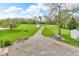 Expansive backyard with a gravel drive, mature trees, and a small shed, offering privacy and space at 5301 Old Smith Valley Rd, Greenwood, IN 46143