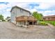 View of the home's deck, gravel driveway, and backyard landscaping features; great for outdoor enjoyment at 5301 Old Smith Valley Rd, Greenwood, IN 46143