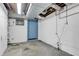 Unfinished basement with concrete floor, white walls, blue door, and exposed ductwork; ready for customization at 5301 Old Smith Valley Rd, Greenwood, IN 46143