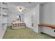 Bedroom showcasing a ceiling fan, blue and yellow carpet, and a comfortable bed at 5301 Old Smith Valley Rd, Greenwood, IN 46143